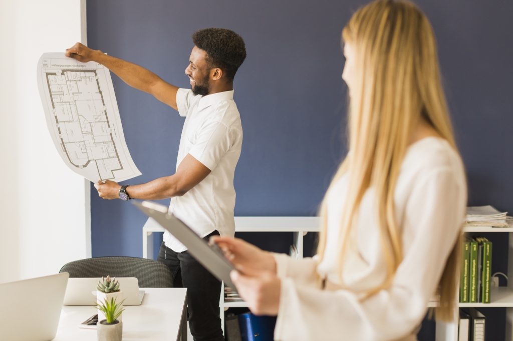 black-man-showing-blueprint-woman