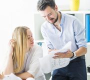 male-female-architect-working-blueprint